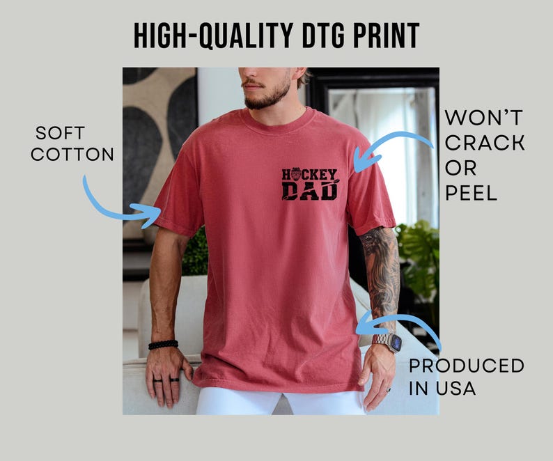 May include: A red short-sleeve t-shirt with the text "HOCKEY DAD" printed on the front. The shirt is made of soft cotton and is produced in the USA. The print won't crack or peel.
