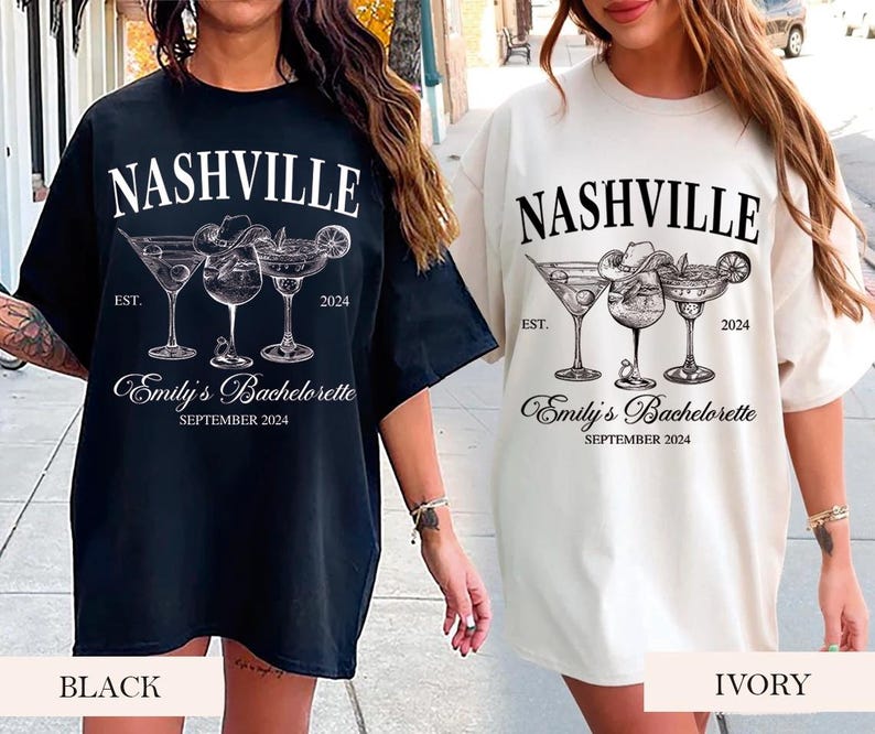May include: Two black and white t-shirts with a graphic of three cocktail glasses and the text "Nashville" and "Emily's Bachelorette" on them. One shirt is black and the other is ivory.
