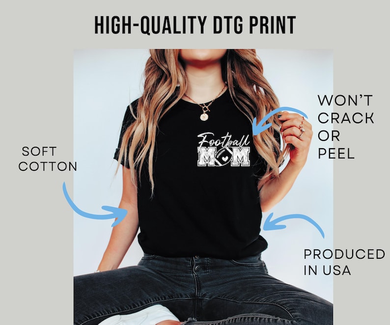 May include: A black t-shirt featuring a white graphic on the chest that reads Football MOM with a football icon. The image includes text labels stating HIGH-QUALITY DTG PRINT, SOFT COTTON, WON'T CRACK OR PEEL, and PRODUCED IN USA.