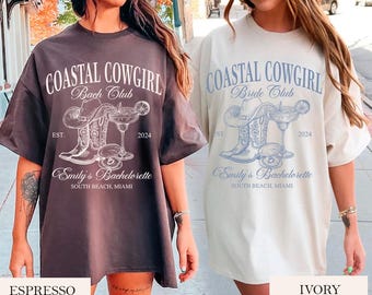 May include: Two oversized t-shirts with a graphic design of a cowboy boot, a margarita glass, and the text "Coastal Cowgirl" in white. The shirt on the left is espresso brown and the shirt on the right is ivory.