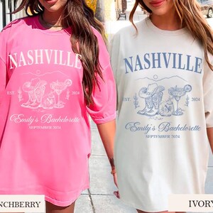 May include: Two oversized t-shirts with a Nashville bachelorette party theme. The t-shirts are in pink and ivory with a graphic of boots, cacti, and a margarita glass. The text on the shirts reads "Nashville", "Est. 2024", "Emily's Bachelorette", and "September 2024".