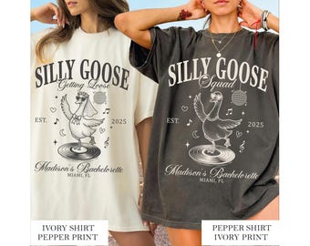 May include: Two oversized t-shirts, one ivory and one pepper, feature a whimsical design for a bachelorette party. The shirts display the text "Silly Goose" with a dancing goose graphic, the year 2025, and "Madison's Bachelorette, Miami, FL."