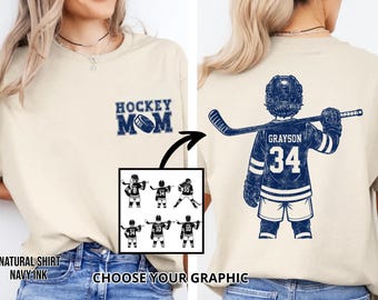 May include: A natural-colored t-shirt with a navy blue "Hockey Mom" graphic on the front. The back features a navy blue hockey player jersey with the name "Grayson" and the number "34". Includes a graphic selection.