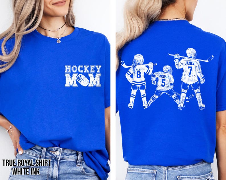 May include: Royal blue t-shirt with white text and graphics. The front features "HOCKEY MOM" with a hockey puck. The back displays three hockey players with names and numbers. The shirt's colour is described as "TRUE ROYAL SHIRT" with "WHITE INK".