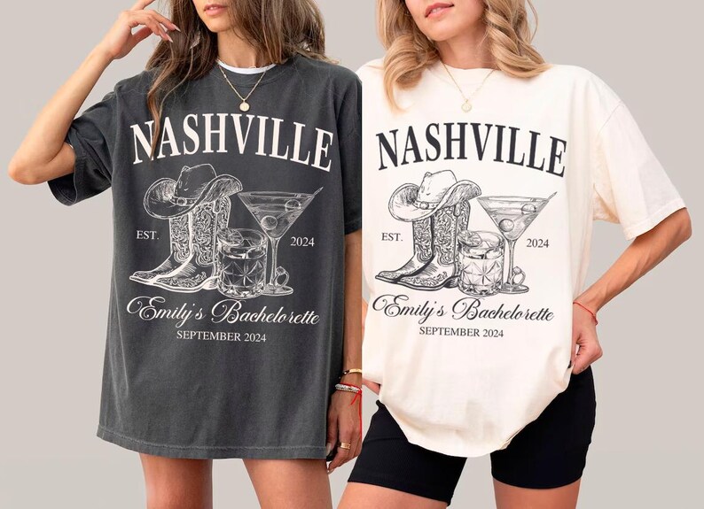 May include: Two gray and white t-shirts with a graphic design of cowboy boots, a cocktail glass, and the text "Nashville Est. 2024 Emily's Bachelorette September 2024".