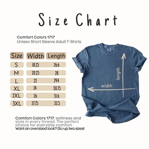 May include: A size chart for Comfort Colors 1717 unisex short sleeve adult t-shirts. The chart lists sizes S through 3XL with corresponding width and length measurements in inches. A blue t-shirt is shown with arrows indicating width and length.