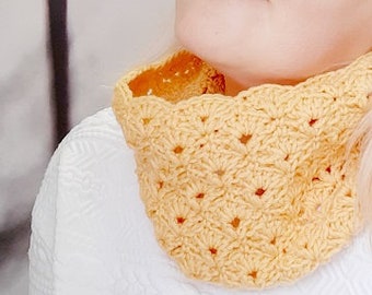 May include: A yellow crocheted neck warmer with a textured pattern.