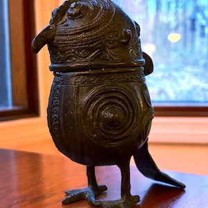 May include: A set of three ceramic mugs with a speckled, matte finish. The mugs are in shades of cream, light gray, and dark gray. Each mug has a simple, minimalist design, perfect for coffee or tea.