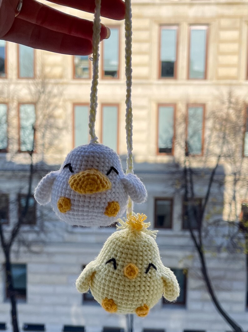 Crochet PDF Pattern for little baby yellow chicken with with yellow orange feathers and white baby duck with orange beak. These two baby animals are joined with crocheted chain to be used as car rear mirror hanger, or to be hanged anywhere in general