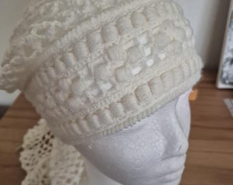 May include: A white crocheted hat with a lacy design. The hat is on a white mannequin head.