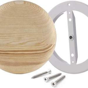 May include: A light-colored wooden sphere with visible grain, a white metal mounting ring, and three silver screws. The sphere is the focal point, suggesting a decorative or functional item.