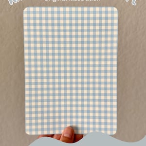 May include: A light blue and white gingham pattern cardstock insert for a Kindle. The text "Kindle Cardstock Insert" and "Original Illustration" is printed at the top of the cardstock. The text "Pattern C" is printed at the bottom of the cardstock.