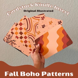 May include: Four cardstock Kindle inserts with fall boho patterns are held in a hand. The inserts display peach, orange, and brown designs, including floral, geometric, and wavy patterns. Text at the top reads "Cardstock Kindle Insert Original Illustrated."