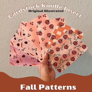 May include: Cardstock Kindle inserts with autumn patterns. The inserts feature various designs, including pumpkins, leaves, and other autumn-themed illustrations. The colour palette includes shades of orange, pink, and brown. The text "Cardstock Kindle Insert" and "Fall Patterns" are visible.