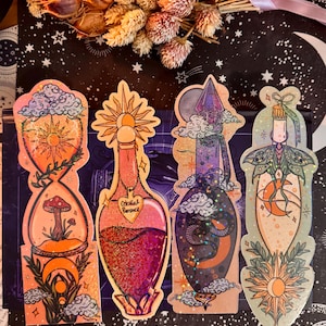 May include: Four decorative, colorful potion bottle-shaped stickers. Each sticker features unique designs, including a sun, mushroom, and celestial elements. The bottles have glitter accents and the text "Celestial Romance" on one.