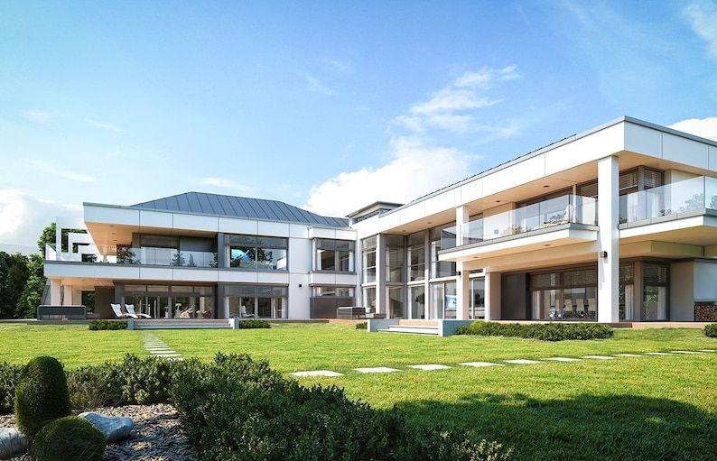 Backyard view of a stylish modern house with open balconies, a wooden deck, and a large green lawn. Suitable for house plans with outdoor living spaces.