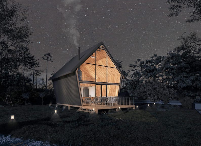 Cozy A-frame house illuminated at night under a starry sky, featuring a glass facade and wooden deck. Perfect for tiny home plans, cottage house designs, or small cabin retreats in tranquil settings.