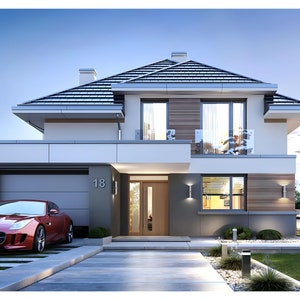 Front view of a luxury modern house featuring a garage and sleek design, ideal for modern house plans and house blueprint seekers.