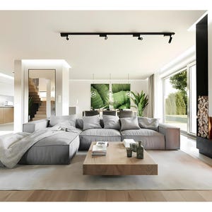 Luxury Open-Concept Living Room Design – A stunning modern living room with cozy neutral-toned sofas, a built-in fireplace, and floor-to-ceiling glass doors. Ideal for contemporary house plans. #floorplans #tinyhomeplans #modernhouseplans