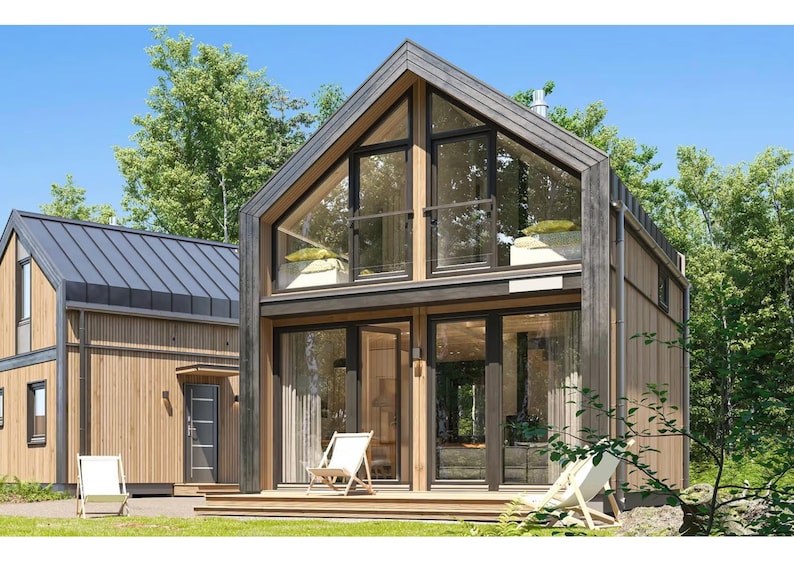 Contemporary wooden cabin with a pitched roof and floor-to-ceiling glass windows. Surrounded by lush greenery, it features a spacious balcony, natural light-filled interiors, and a serene outdoor seating area for relaxation.