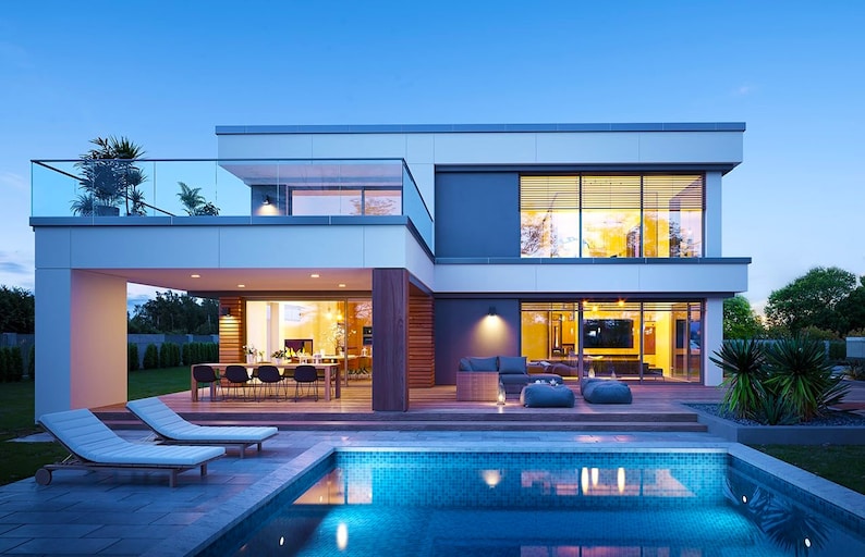 A luxurious villa exterior with elegant architectural details, large windows, and a landscaped backyard. Perfect inspiration for cottage house plans or modern barndominium plans.