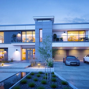 The backyard of a modern house with a swimming pool, wooden deck, and outdoor seating area. An excellent fit for modern house plans or those exploring small cabin plans.