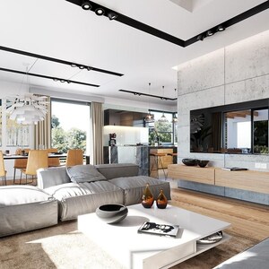 May include: A spacious open-concept living room featuring a large gray modular sofa, a white square coffee table, and a light wood floating media console mounted on a concrete wall with a flat-screen television and black track lighting.