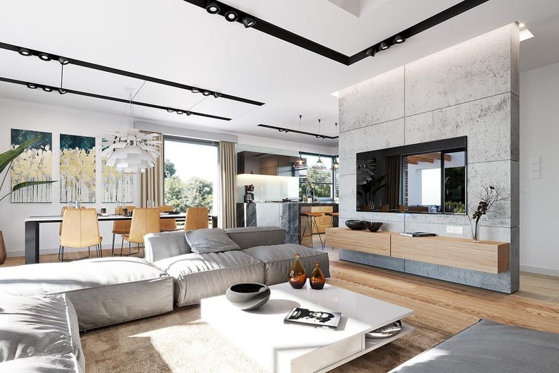 May include: A spacious open-concept living room featuring a large gray modular sofa, a white square coffee table, and a light wood floating media console mounted on a concrete wall with a flat-screen television and black track lighting.