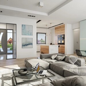Open-plan living room with a modern fireplace, cozy gray furniture, and a stylish dining area, showcasing the interior of a townhouse plan.