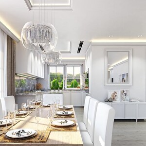 May include: A dining room featuring a long wooden table with white chairs, set with white plates and glassware. Above the table hang two clear glass pendant lights. A white sideboard with a mirror and framed art sits against the wall.