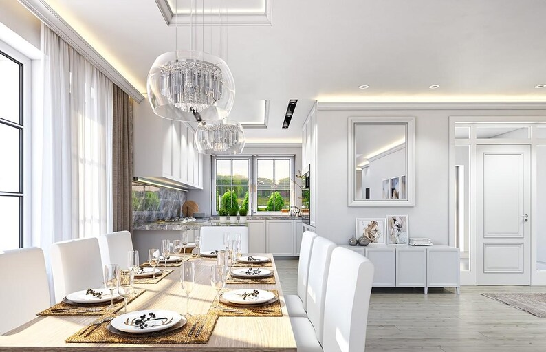 May include: A dining room featuring a long wooden table with white chairs, set with white plates and glassware. Above the table hang two clear glass pendant lights. A white sideboard with a mirror and framed art sits against the wall.
