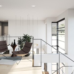 May include: Modern interior design featuring a light-filled space with a staircase and a seating area. Two brown leather chairs with metal legs are positioned near a small side table with decorative vases. The room has large windows with blinds and abstract art on the wall.