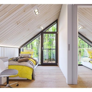 Bright attic bedroom with sloped wooden ceilings, cozy beds, and a study desk. Features large glass doors opening to a serene forest view, blending natural light with a peaceful ambiance.