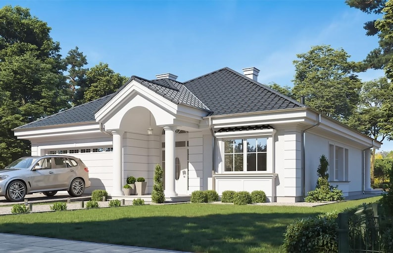 May include: A single-story white house with a dark gray tiled roof, a front porch supported by two white columns, and a white garage door. A silver SUV is parked in the driveway, and the house is surrounded by a green lawn and trees.