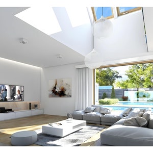 Bright living room with skylights, large glass doors to a pool, and minimalist decor. Features a modern seating area, wooden floors, and natural light. Perfect for open-concept home designs and contemporary living spaces.