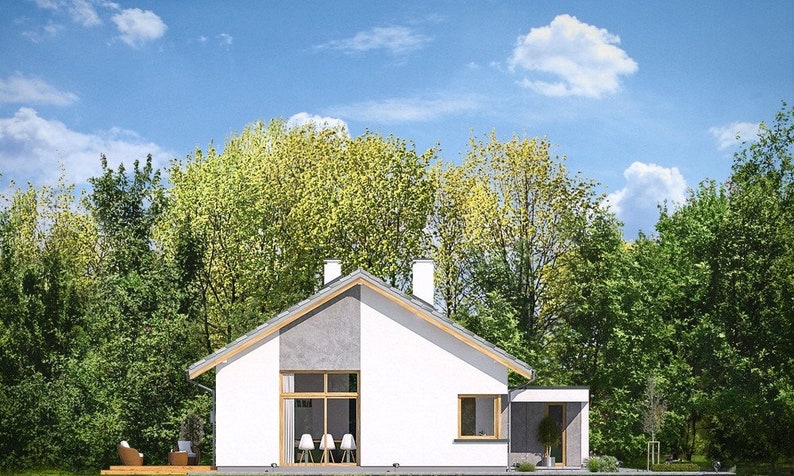 Rear view of a Scandinavian modern house with a sleek gable roof, cozy patio, and forested background. Ideal for anyone seeking small cabin plans or barndominium-inspired layouts.