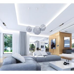 Spacious modern living area featuring an open floor plan, large windows, and elegant lighting fixtures. Includes cozy seating, a fireplace, and wood panel accents. Ideal for contemporary house plans and luxurious interiors.