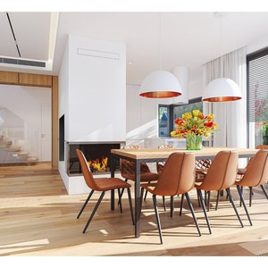 A cozy dining area featuring Scandinavian-style chairs, wooden floors, and a large glass window opening to the garden, ideal for modern and Scandinavian house plans