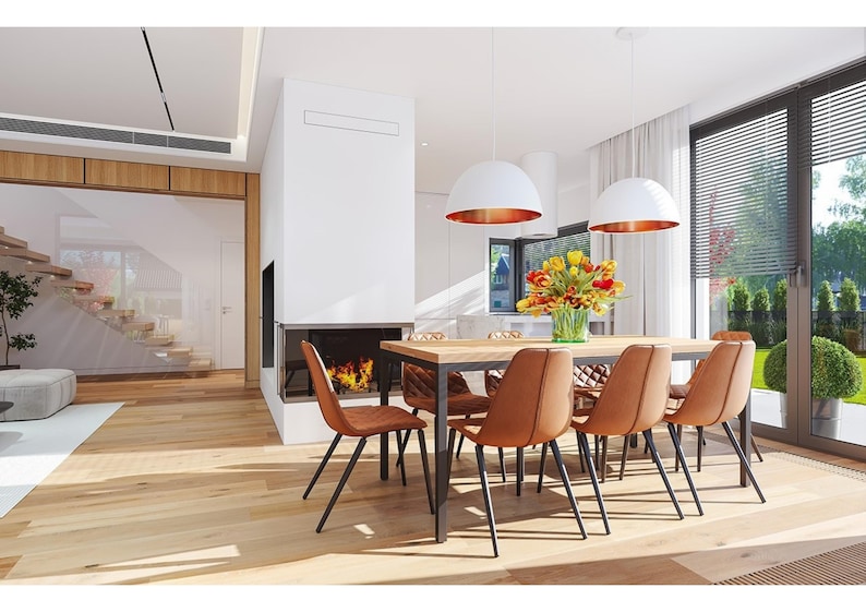 A cozy dining area featuring Scandinavian-style chairs, wooden floors, and a large glass window opening to the garden, ideal for modern and Scandinavian house plans