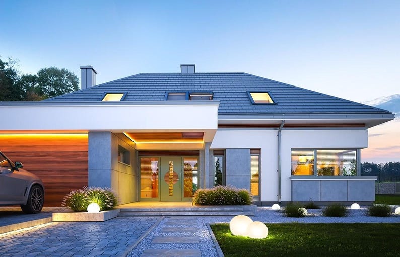 May include: A modern single-story house with a gray tiled roof, white exterior walls, and wood paneling on the garage. The entrance features a light green door with glass panels, illuminated by warm LED strip lighting and spherical garden lights.