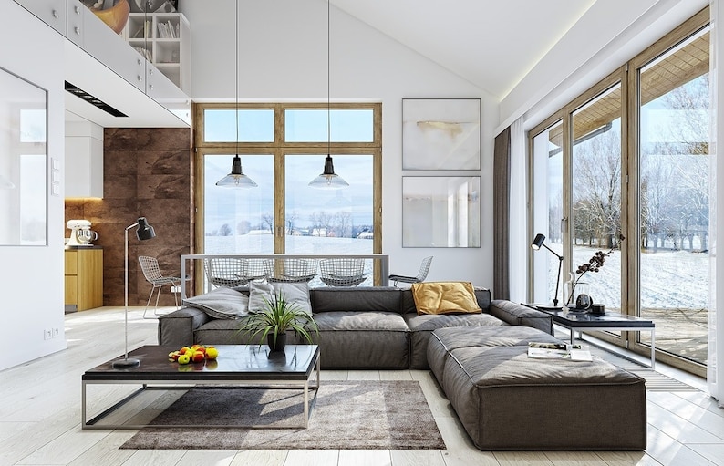 Bright, modern living room interior with Scandinavian-style decor, a large sectional sofa, floor-to-ceiling windows, and a view of the snowy outdoors. Perfect for tiny house plans and townhouse inspirations.