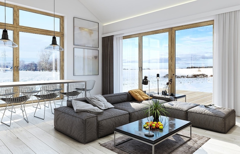 Contemporary living and dining space with open-concept design, minimalist furniture, and natural lighting from large windows. A great example of modern house plans and functional layouts.