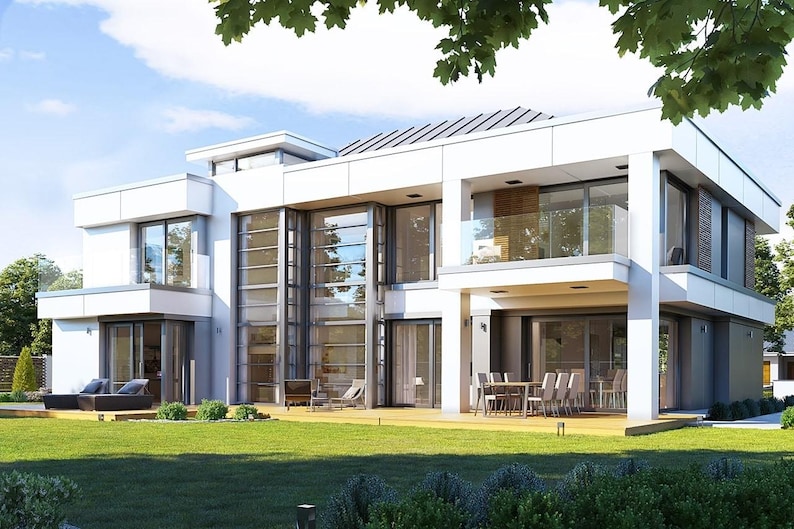 May include: A modern, two-story house with a white exterior, large glass windows, and a flat roof. The house has a balcony, a patio with a dining table, and a well-maintained green lawn. The sky is blue with some clouds.