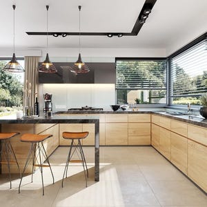 May include: A modern kitchen featuring light wood cabinetry, a dark marble countertop, and three bar stools with tan leather seats and black metal wire bases. Three black pendant lights hang above the kitchen island.
