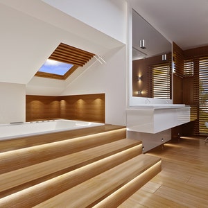 Luxury bathroom with wooden accents, recessed lighting, and a large bathtub. A stunning addition to modern house plans and blueprints.