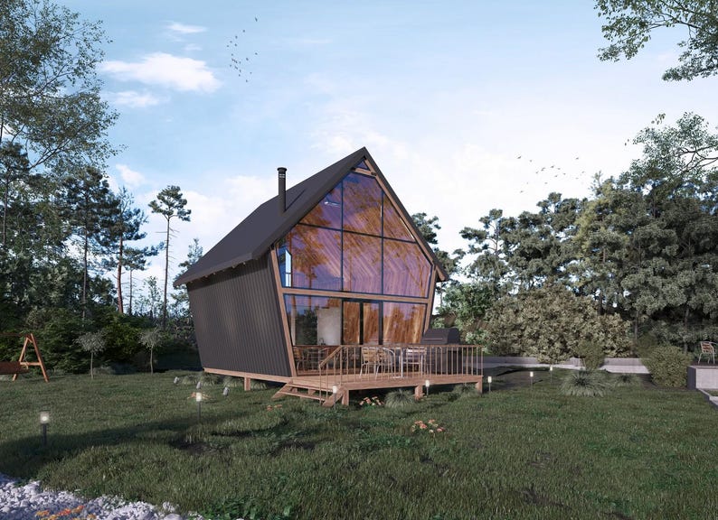 Modern A-frame house design with a striking glass facade, elevated wooden deck, and natural surroundings. Ideal for cottage house plans, tiny home designs, or small cabin layouts, perfect for scenic retreats.