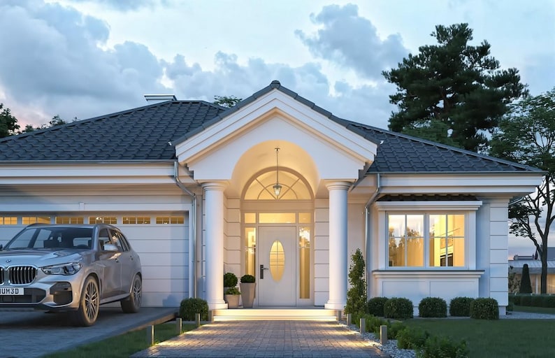 May include: A single-story white house with a dark gray tiled roof, a central arched entryway supported by two white columns, and a silver SUV parked in the attached garage driveway. The front door features an oval glass window insert.
