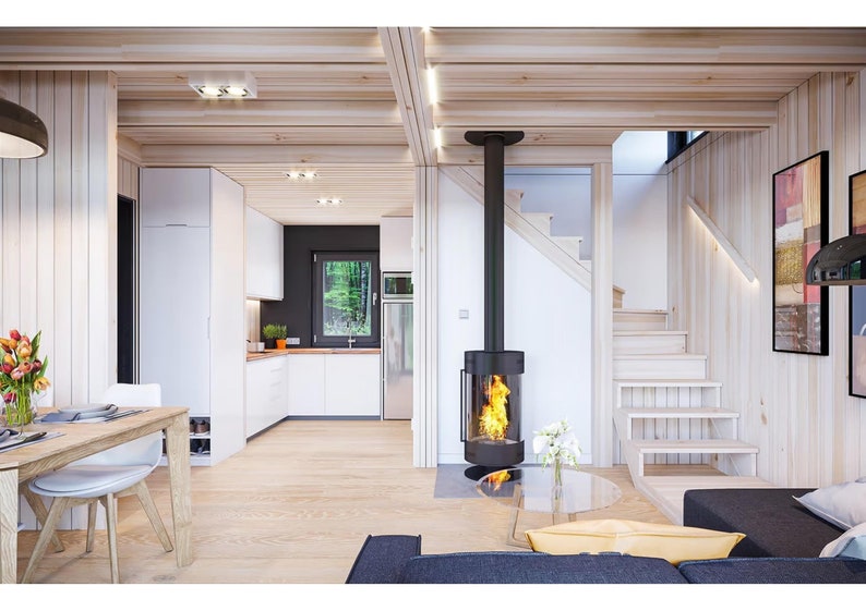 Cozy modern interior with a wood-paneled design, featuring a central fireplace, open kitchen, and staircase leading to the upper level. Warm tones and natural light create a welcoming and functional living space.