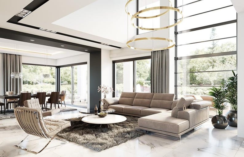 May include: A modern living room with a neutral color palette. Features include a large sectional sofa, a round coffee table, and a contemporary chair. Large windows offer a view of the outdoors. A stylish chandelier hangs from the ceiling.