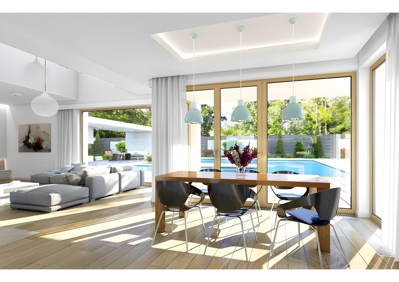 Modern villa interior featuring an open-plan living and dining area with large windows letting in natural light. Offers a pool view, minimalist decor, and elegant wooden furniture, creating a luxurious living experience.